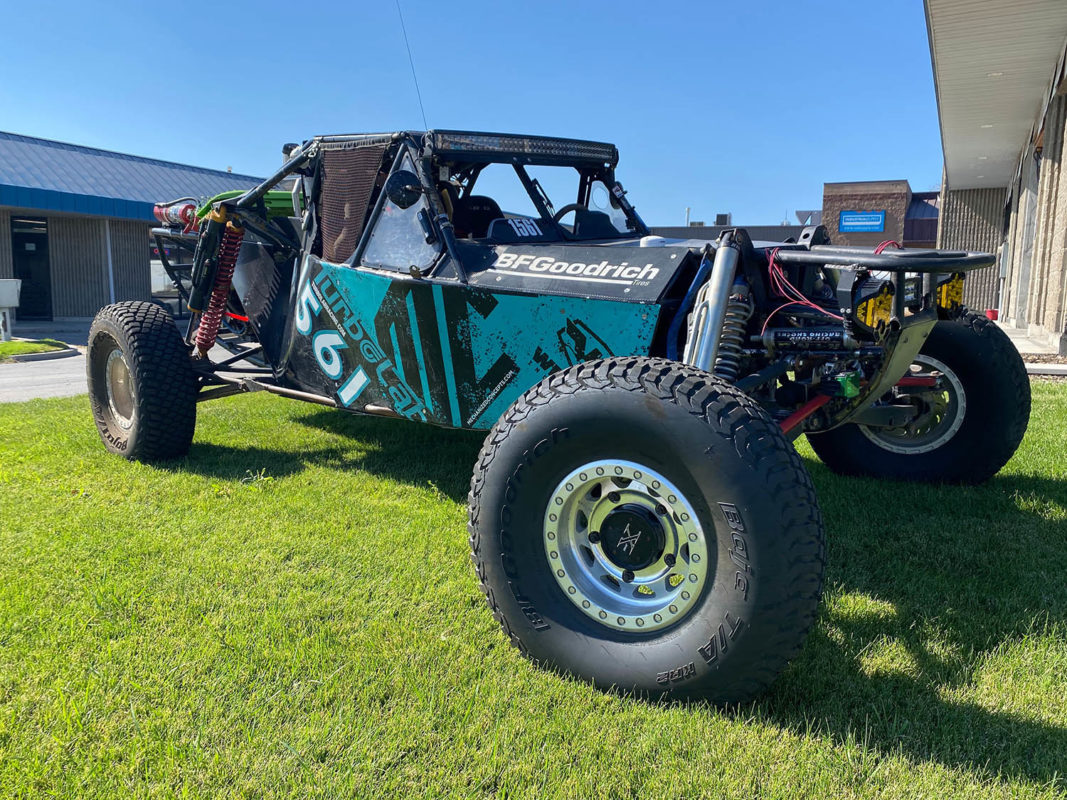 Image of a black and turquoise TurboLab Offroad Vehicle on green lawn